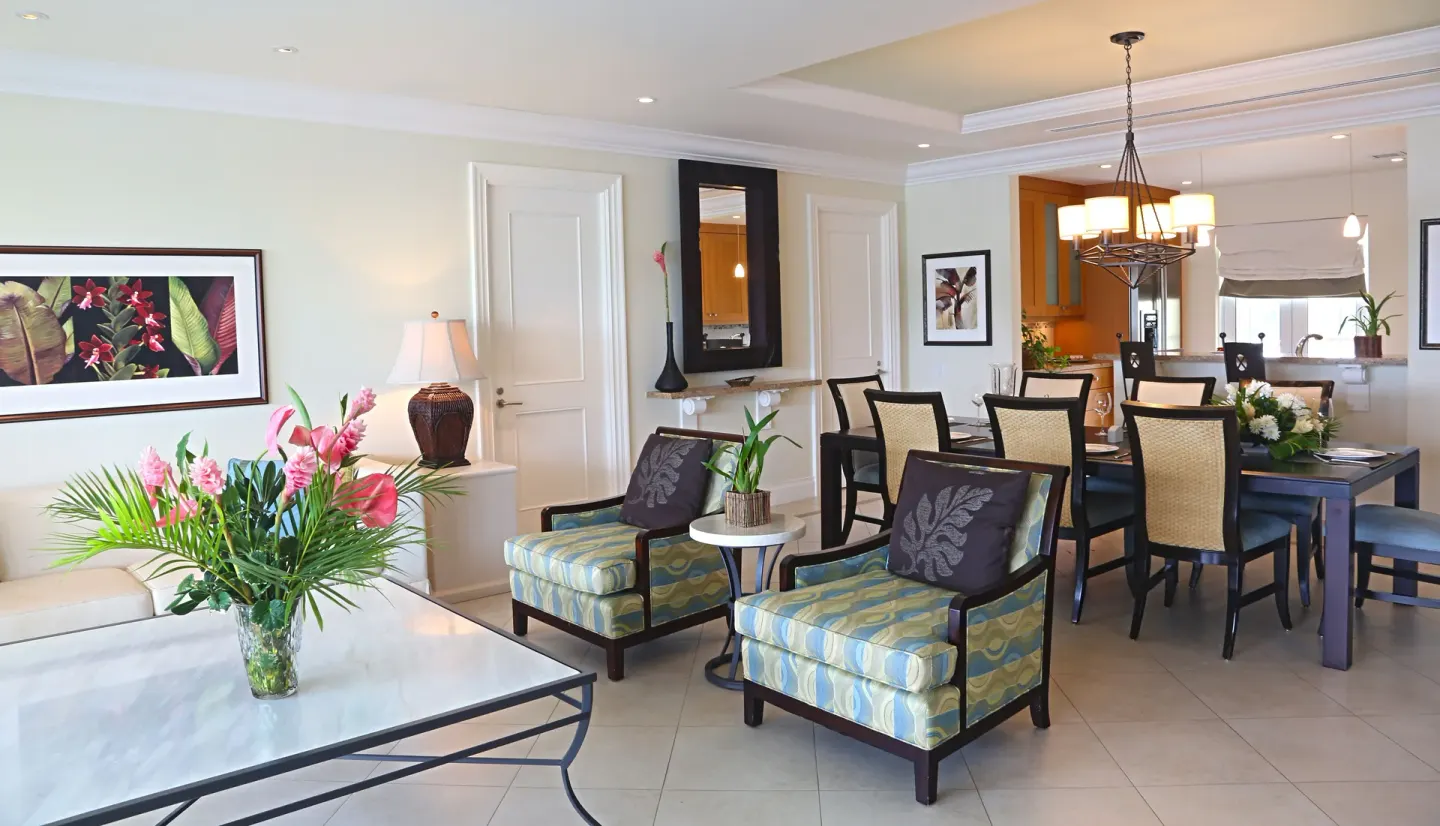 Villa suite living and dining area at The Landings Resort & Spa with chairs, table, and kitchen.