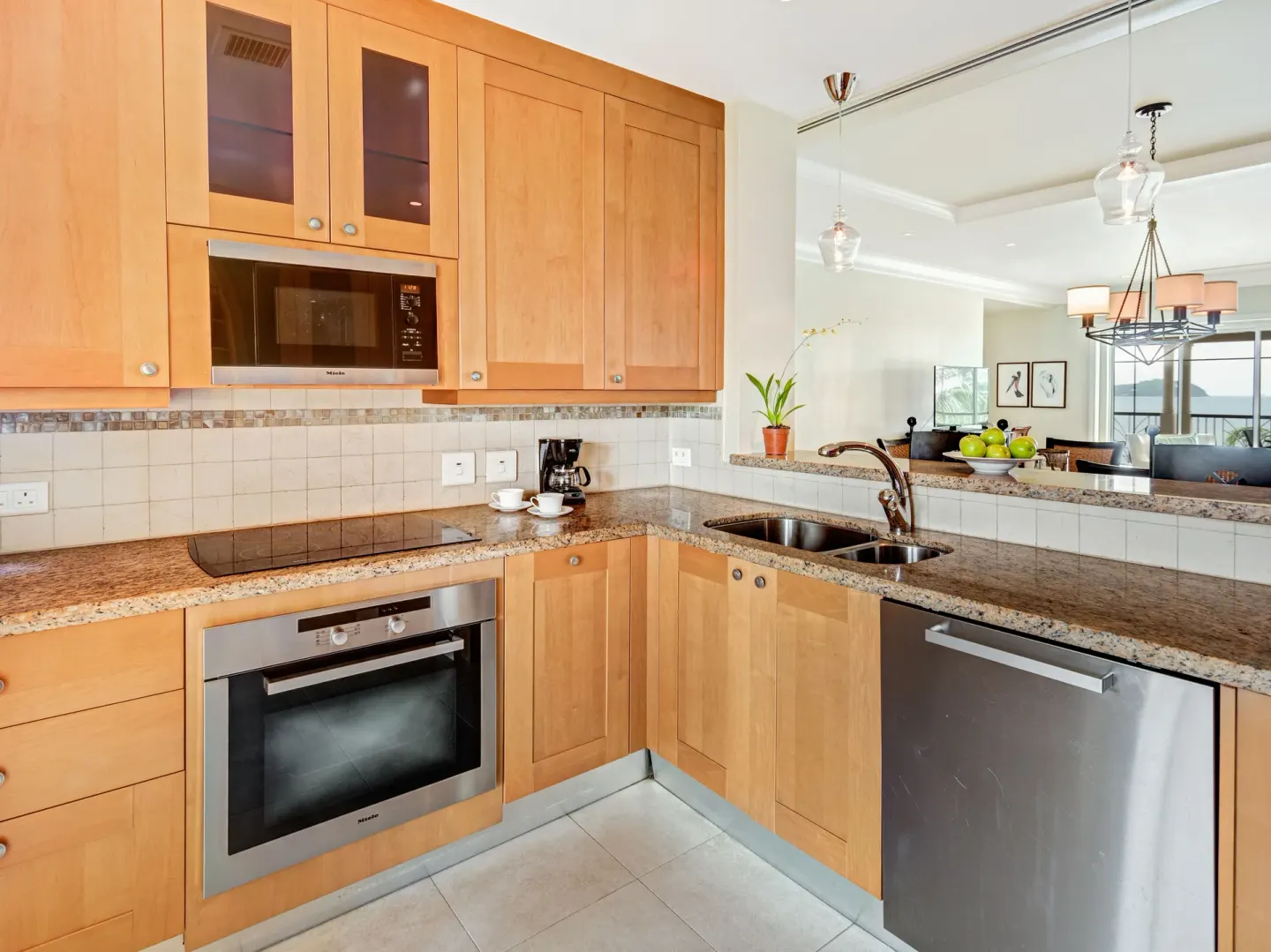 Villa suite kitchen with wood cabinetry and stainless appliances at The Landings Resort & Spa.