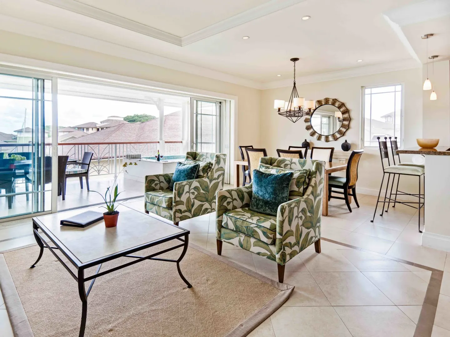 Living and dining room with balcony in a 3 Bedroom Villa Suite Marina View at The Landings Resort & Spa.