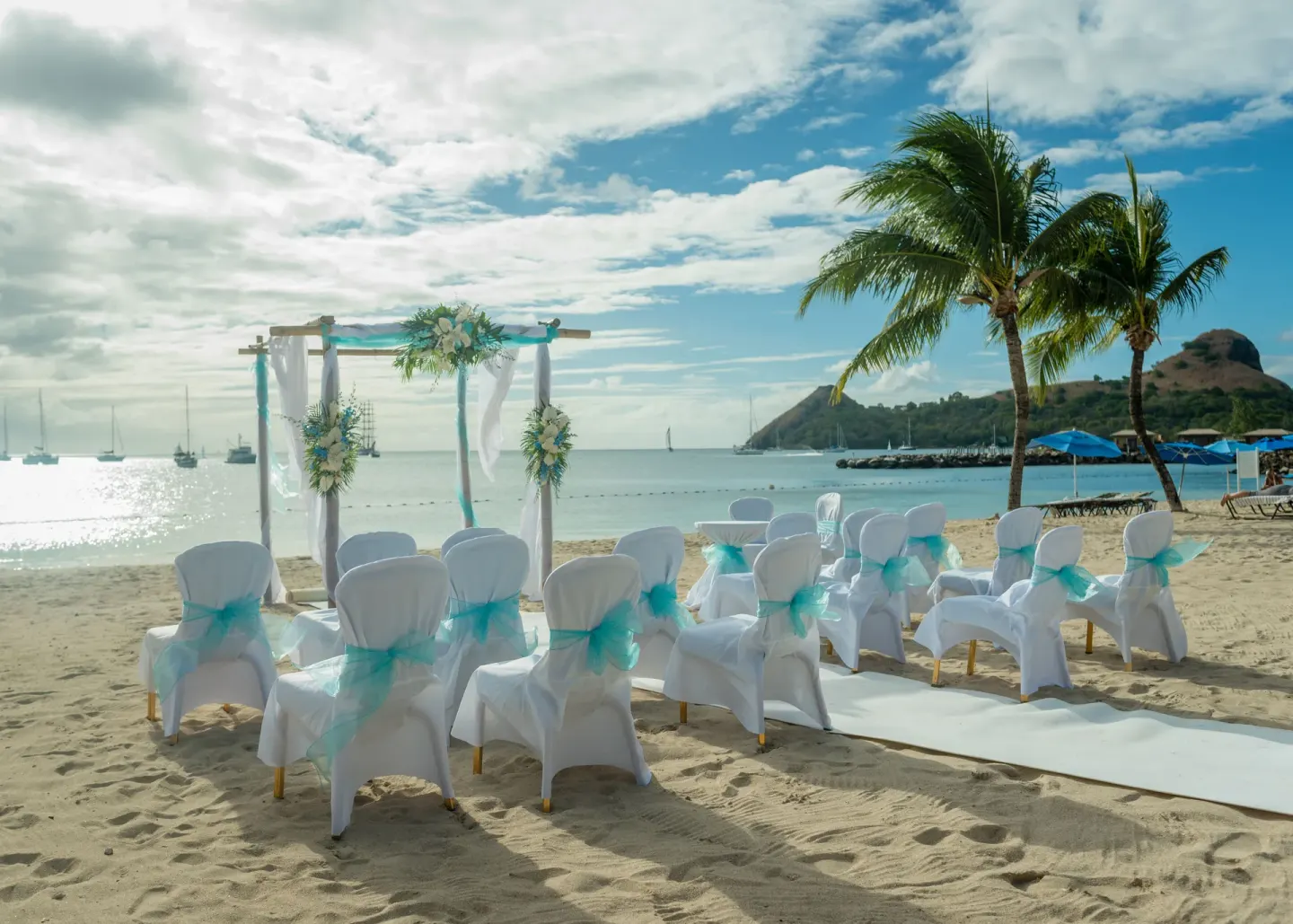 A beach wedding setup faces the water at The Landings Resort & Spa.
