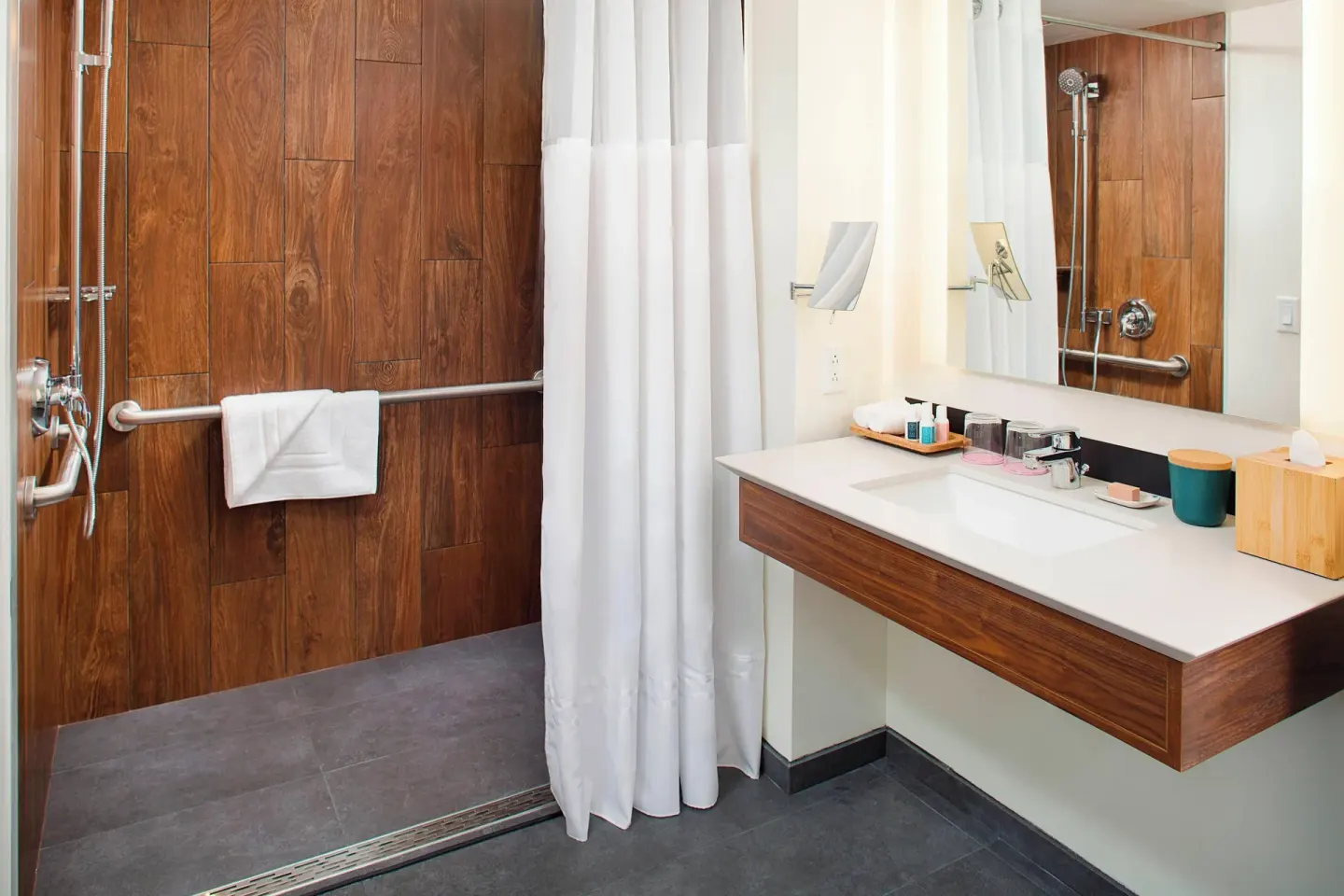 Bathroom vanity and roll-in shower at The Laylow Waikiki, Autograph Collection.