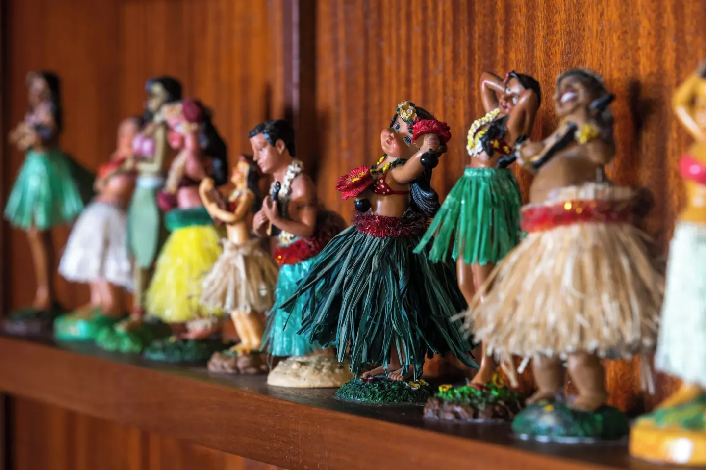 Decorative hula figurines on a shelf at The Laylow Waikiki, Autograph Collection.