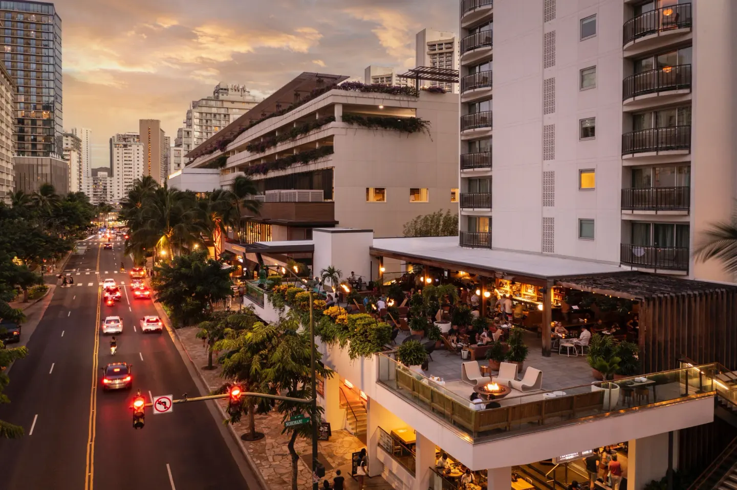 Elevated evening view of the terrace and street at The Laylow Waikiki, Autograph Collection.