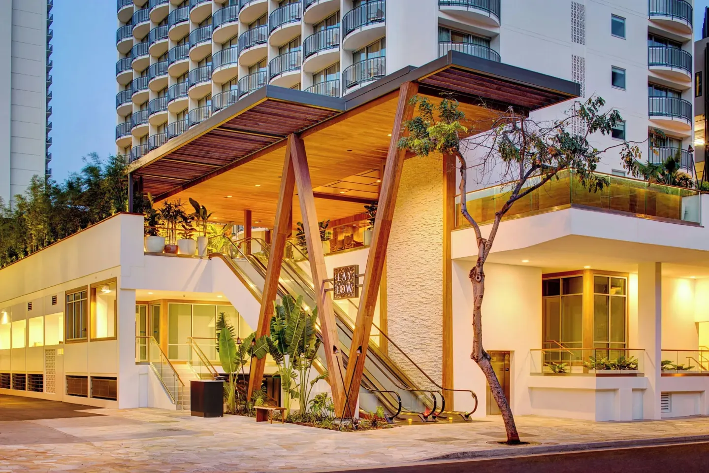 Exterior entrance of The Laylow Waikiki, Autograph Collection with wood canopy.