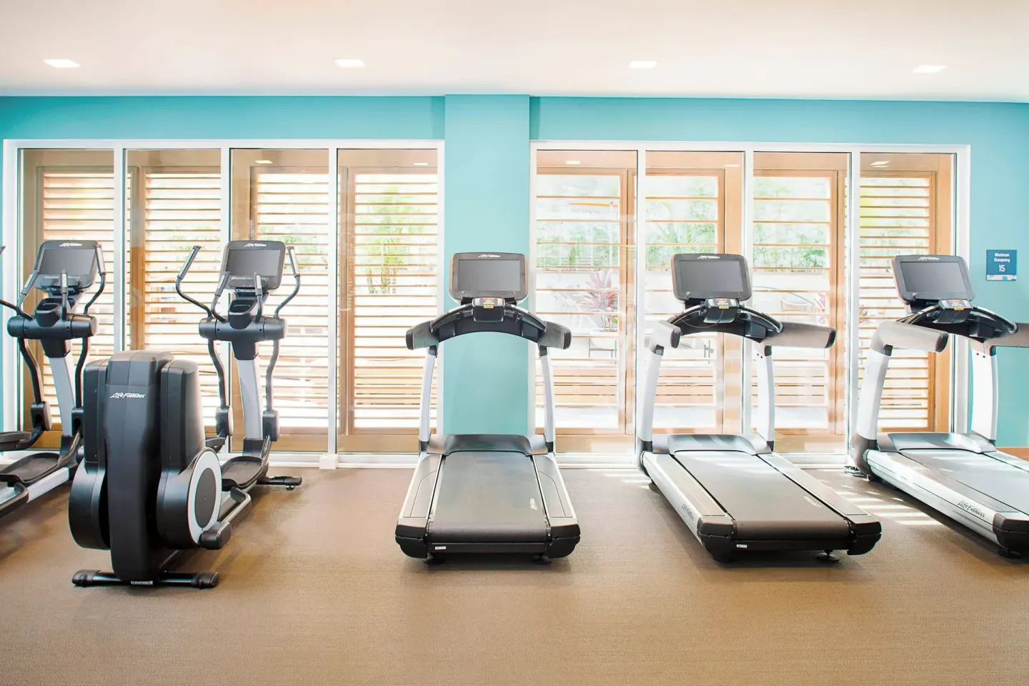 Fitness room treadmills and cardio machines at The Laylow Waikiki, Autograph Collection.