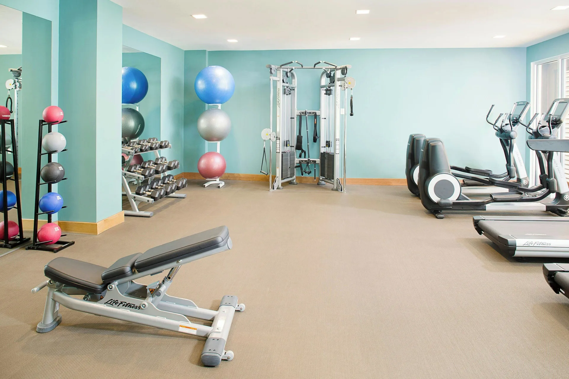 Fitness center with weights and cardio equipment at The Laylow Waikiki, Autograph Collection.