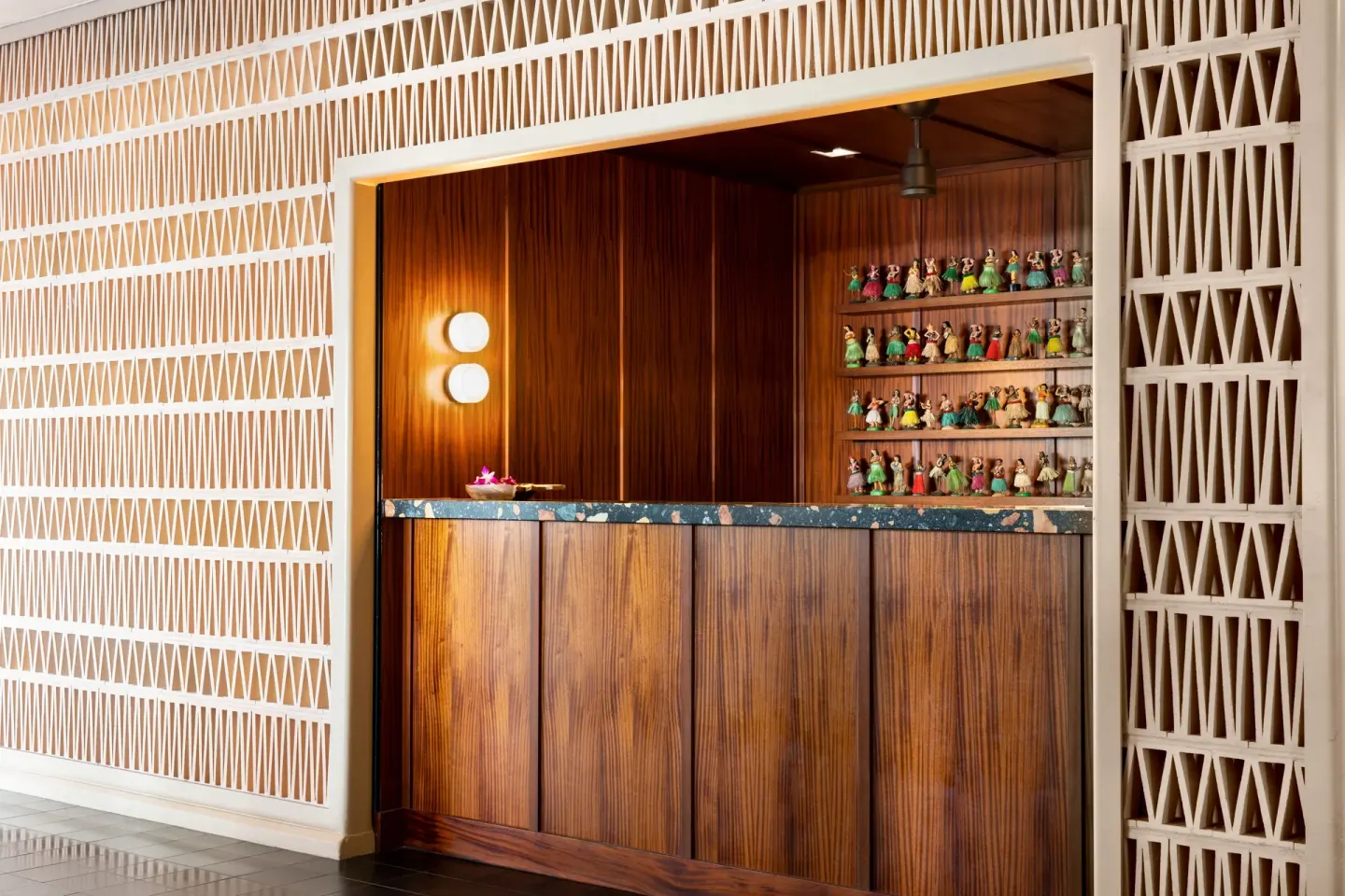 Wood reception counter and decorative wall at The Laylow Waikiki, Autograph Collection.