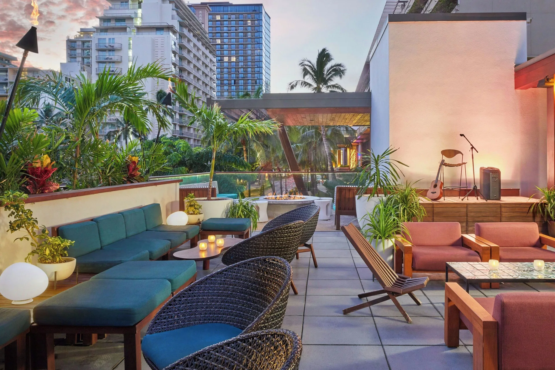 Open-air lounge terrace with small stage at The Laylow Waikiki, Autograph Collection.