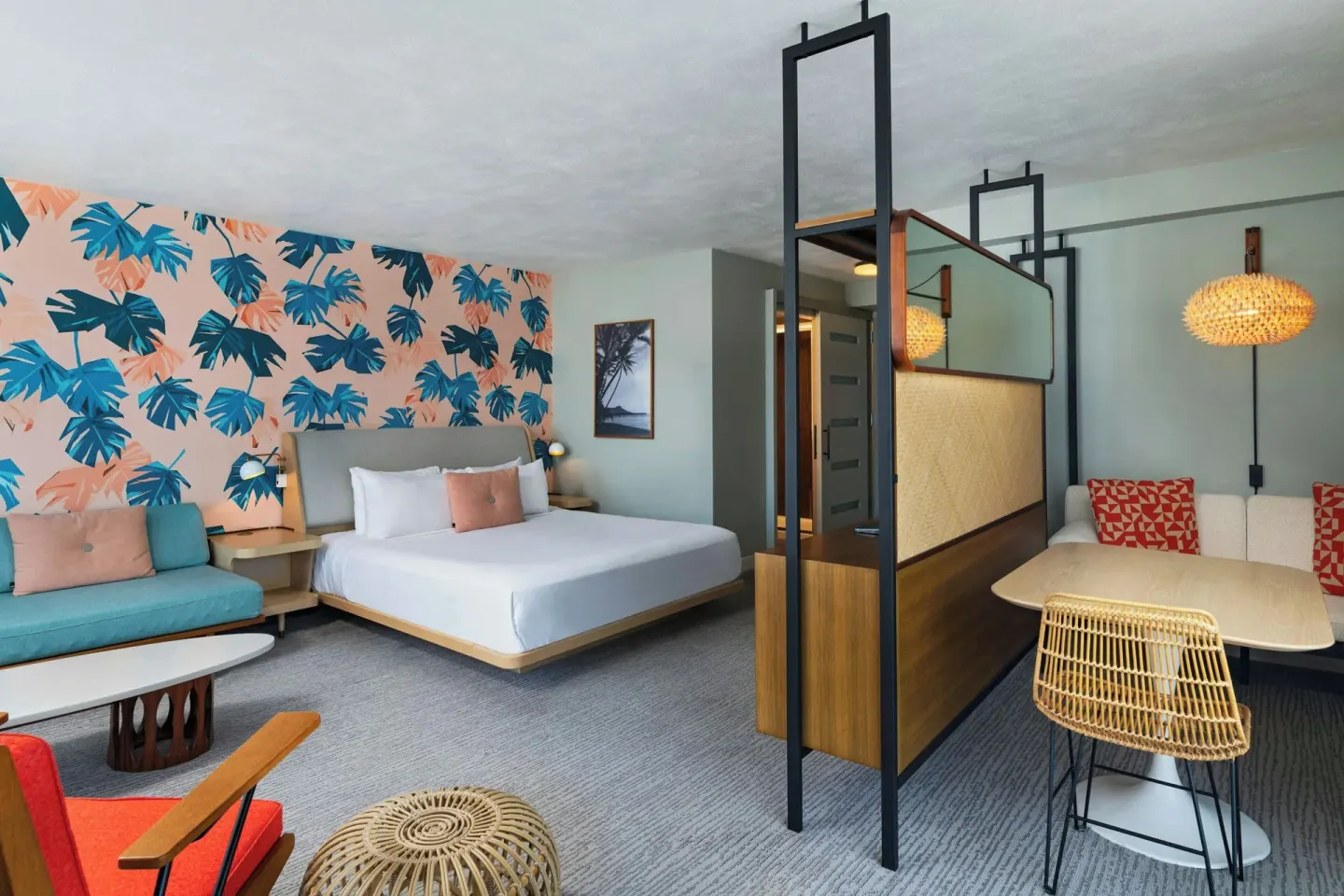 Corner Suite with king bed, daybed, and dining nook at The Laylow Waikiki, Autograph Collection.