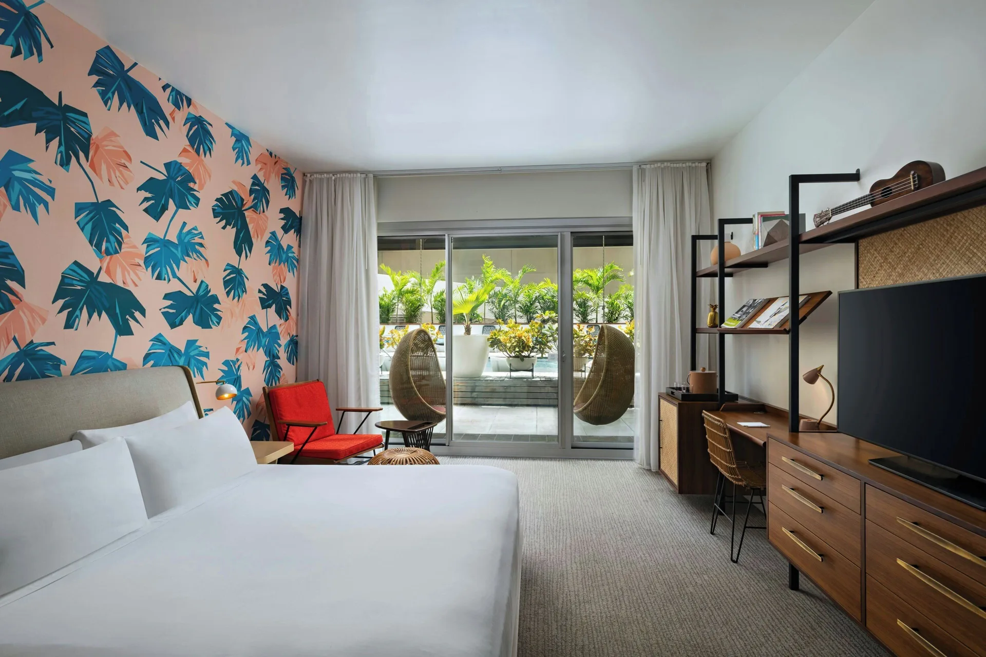 Poolside Room at The Laylow Waikiki with king bed, modern desk, and direct pool access via private patio.