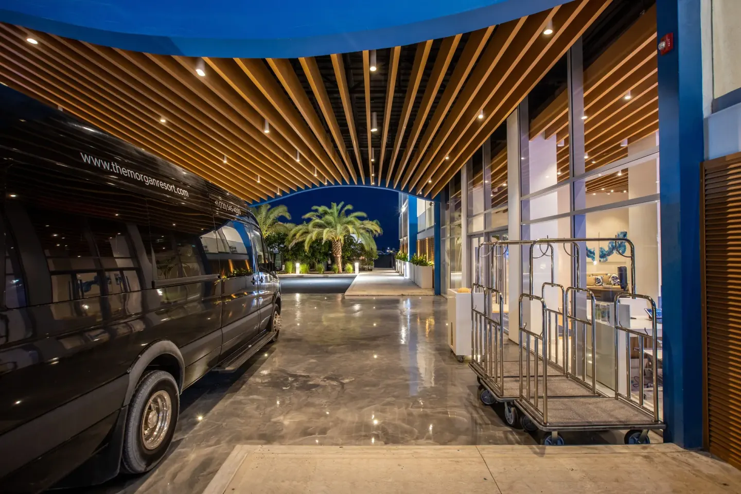 Covered arrival driveway with shuttle van at The Morgan Resort Spa Village.