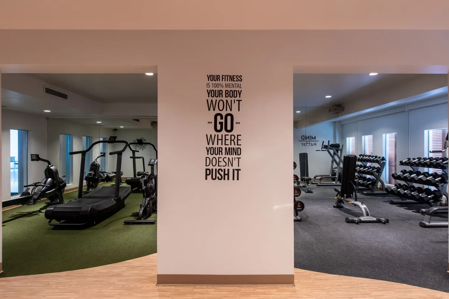 Gym entrance areas with workout machines and a fitness quote at The Morgan Resort Spa Village.