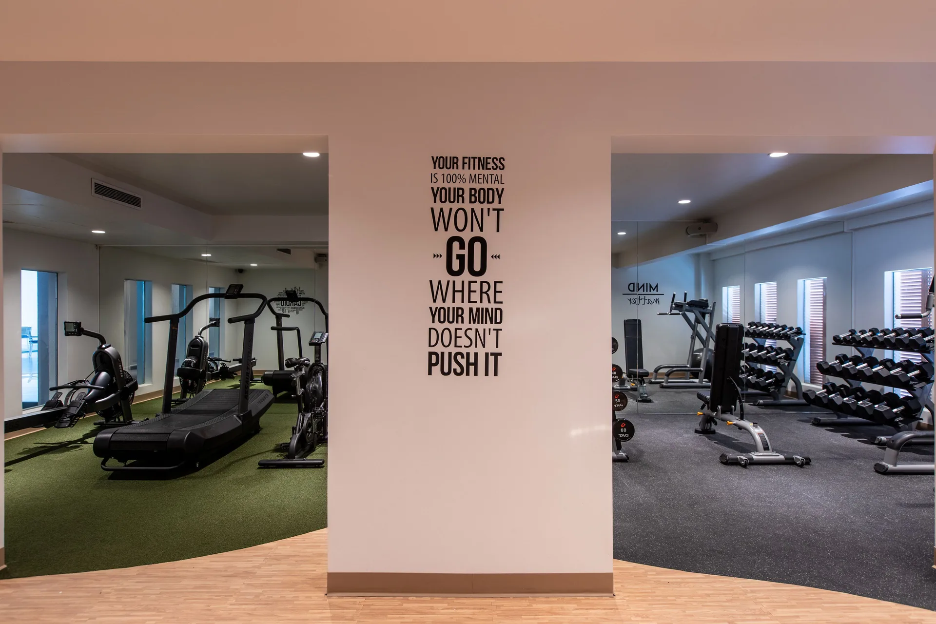 Gym entrance areas with workout machines and a fitness quote at The Morgan Resort Spa Village.