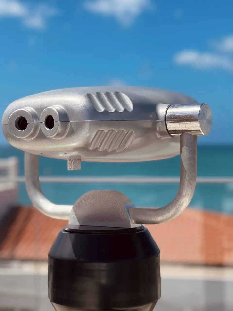 Coin-operated viewing binoculars facing the sea at The Morgan Resort Spa Village.