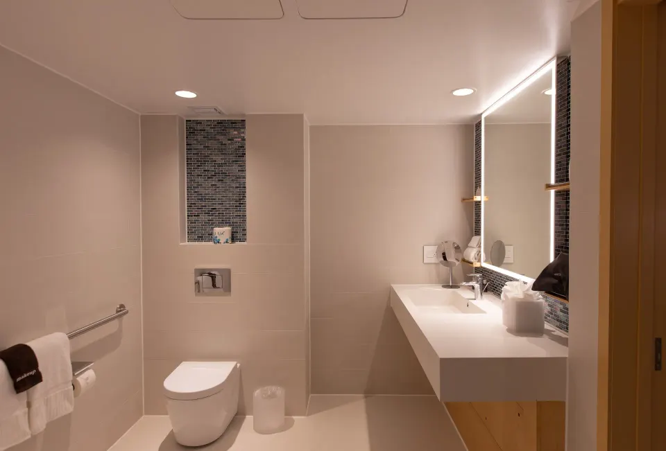 Accessible bathroom vanity, toilet, and grab bar at The Morgan Resort Spa Village.