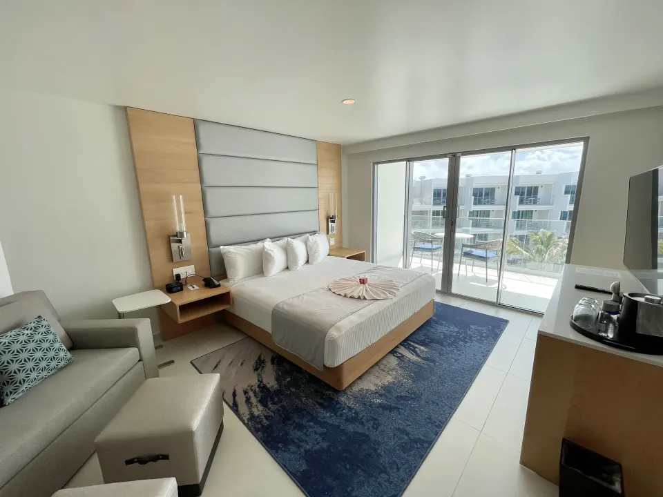 Deluxe Oceanfront Suite with king bed and balcony at The Morgan Resort Spa Village.