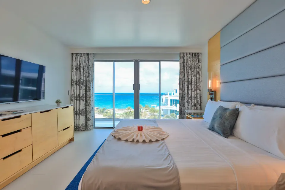 Deluxe Oceanfront Suite king bed with ocean view at The Morgan Resort Spa Village.
