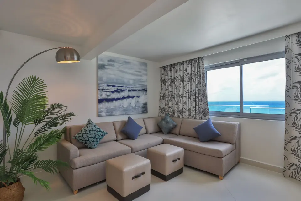 Deluxe Oceanfront Suite living area with sectional sofa at The Morgan Resort Spa Village.