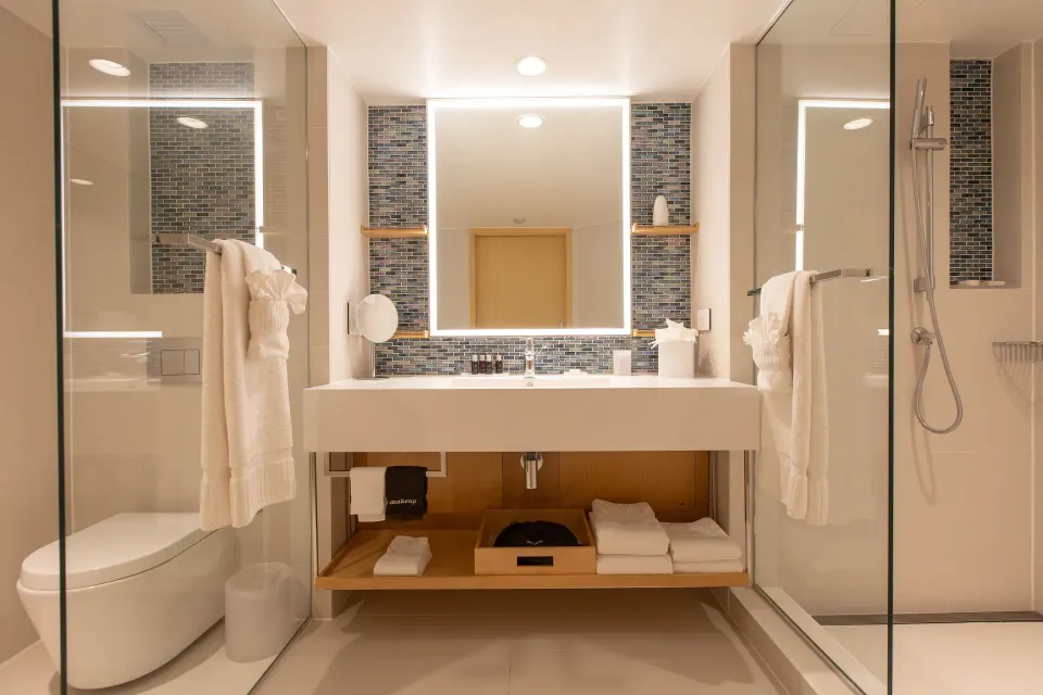Junior Oceanfront Suite bathroom with sink, toilet, and shower at The Morgan Resort Spa Village.