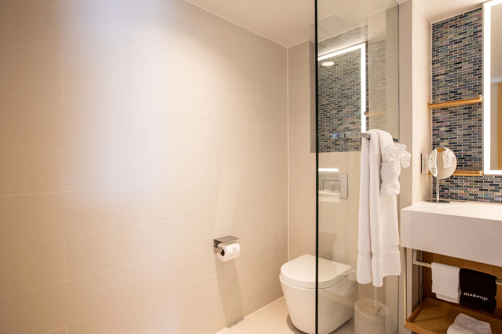 Junior Oceanfront Suite bathroom toilet and vanity detail at The Morgan Resort Spa Village.