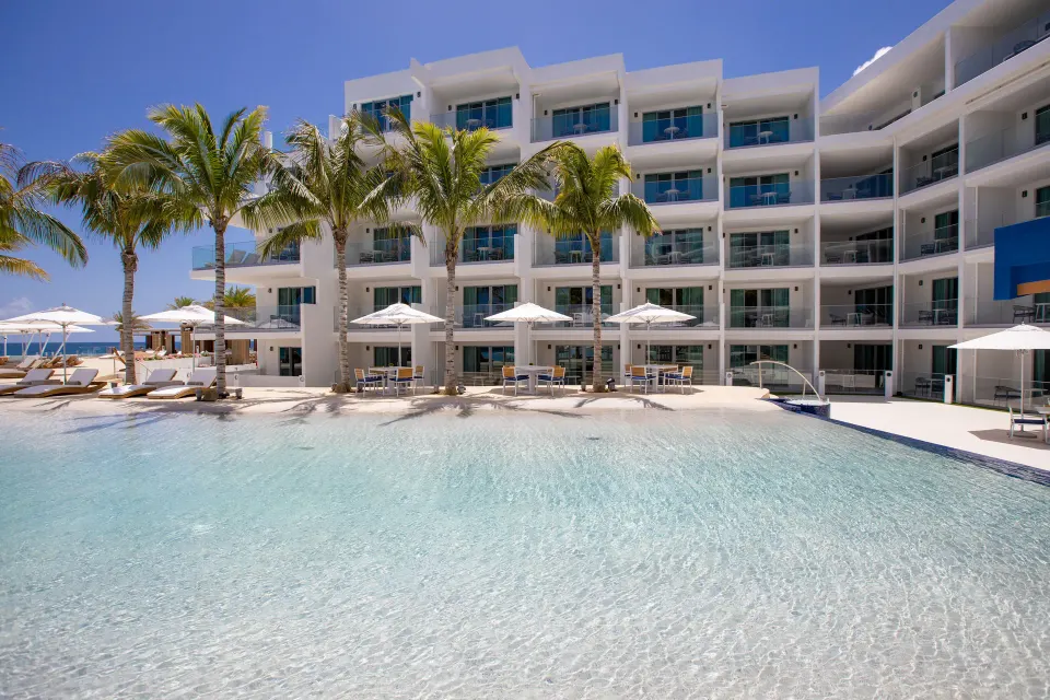 Pool and resort building outside Oceanview Guestrooms at The Morgan Resort Spa Village.