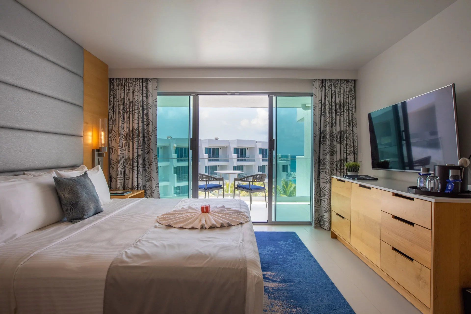 Oceanview Guestroom king bed facing balcony at The Morgan Resort Spa Village.