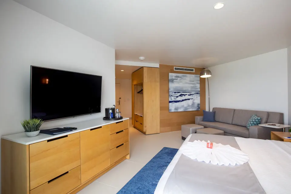 Oceanview Guestroom seating area and TV at The Morgan Resort Spa Village.