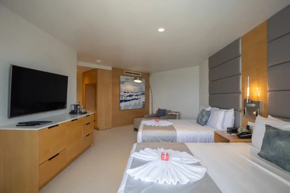 Oceanview Guestroom two beds and TV wall at The Morgan Resort Spa Village.