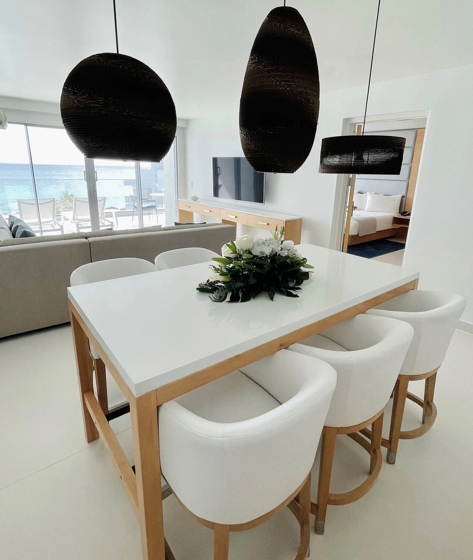Penthouse Oceanfront Suite dining area and bedroom at The Morgan Resort Spa Village.