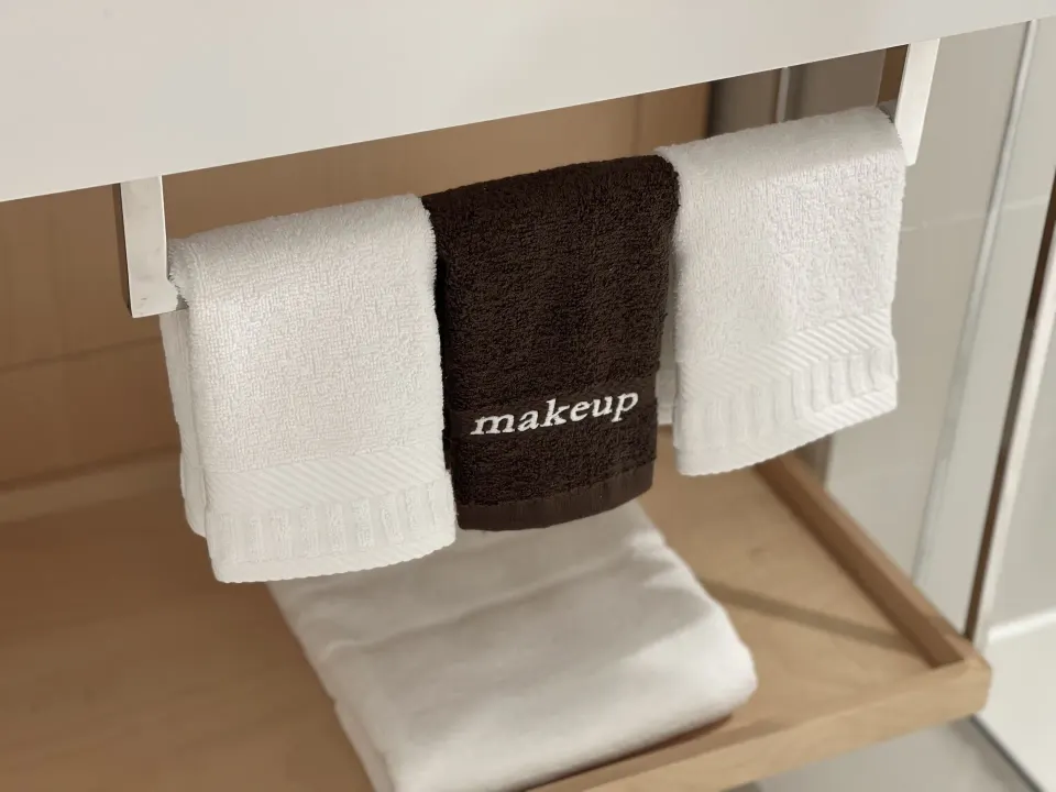 Bathroom towels under the vanity in a Runway View Guestroom at The Morgan Resort Spa Village.