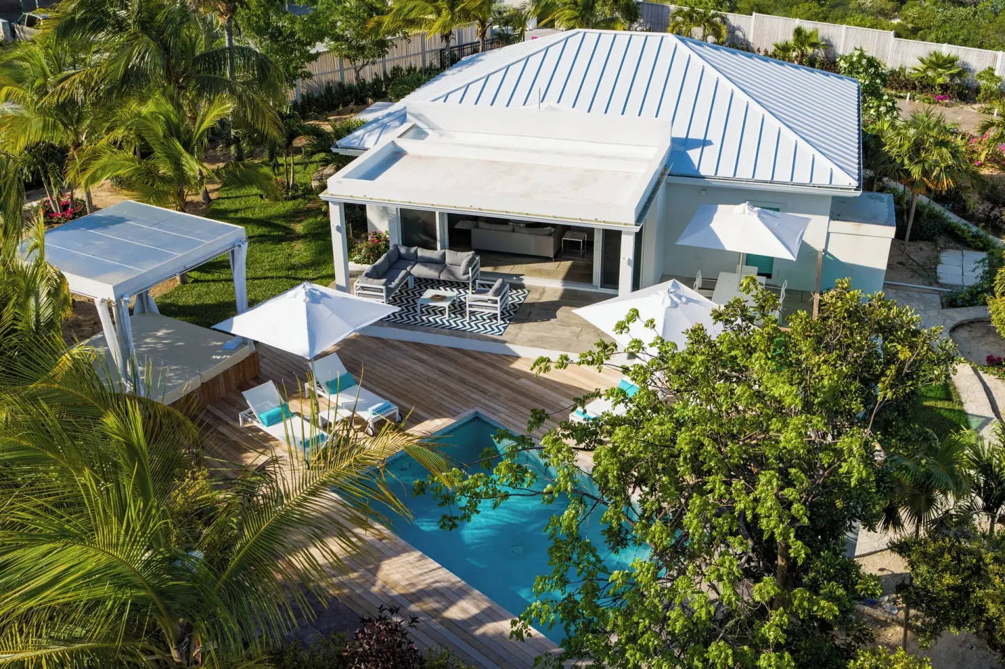 Aerial view of a private pool, deck, and villa at The Oasis at Grace Bay.