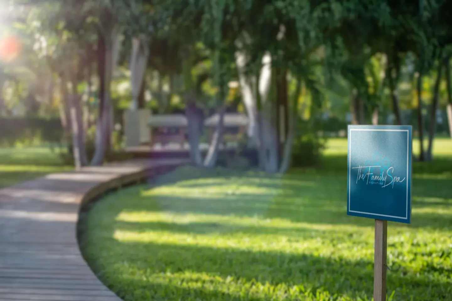 A garden path and spa sign on the lawn at The Oasis at Grace Bay.