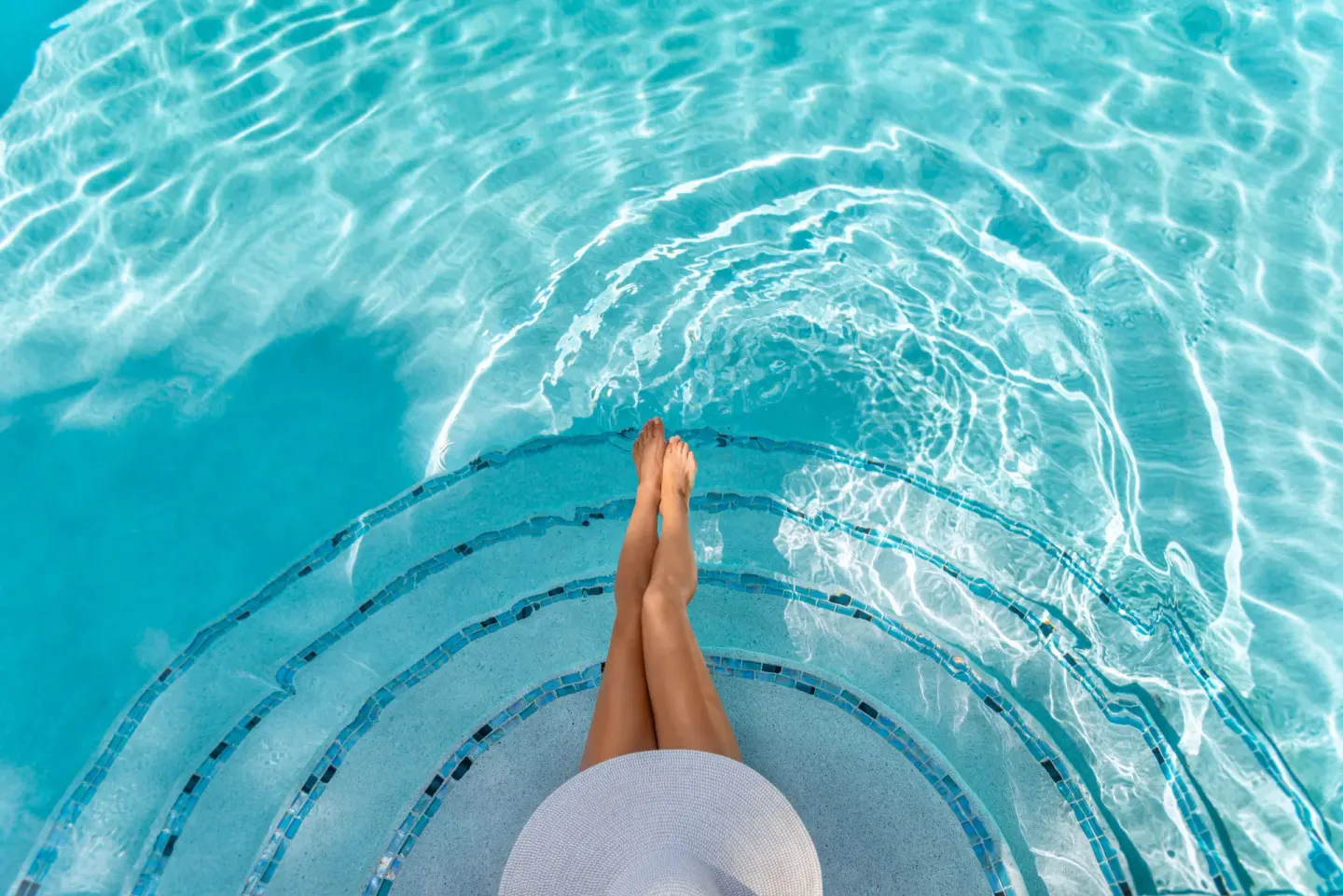 Pool steps and turquoise water at The Oasis at Grace Bay.