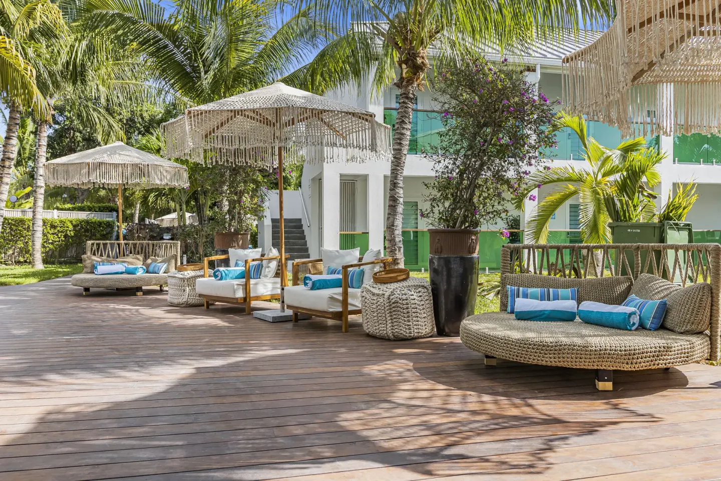Shaded deck seating and fringed umbrellas at The Oasis at Grace Bay.