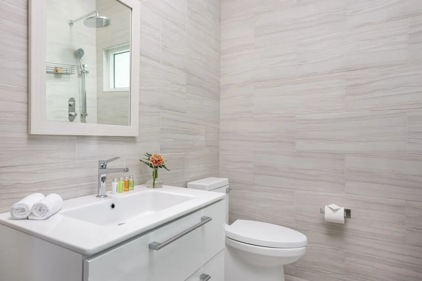 Deluxe Room bathroom vanity and toilet at The Oasis at Grace Bay.
