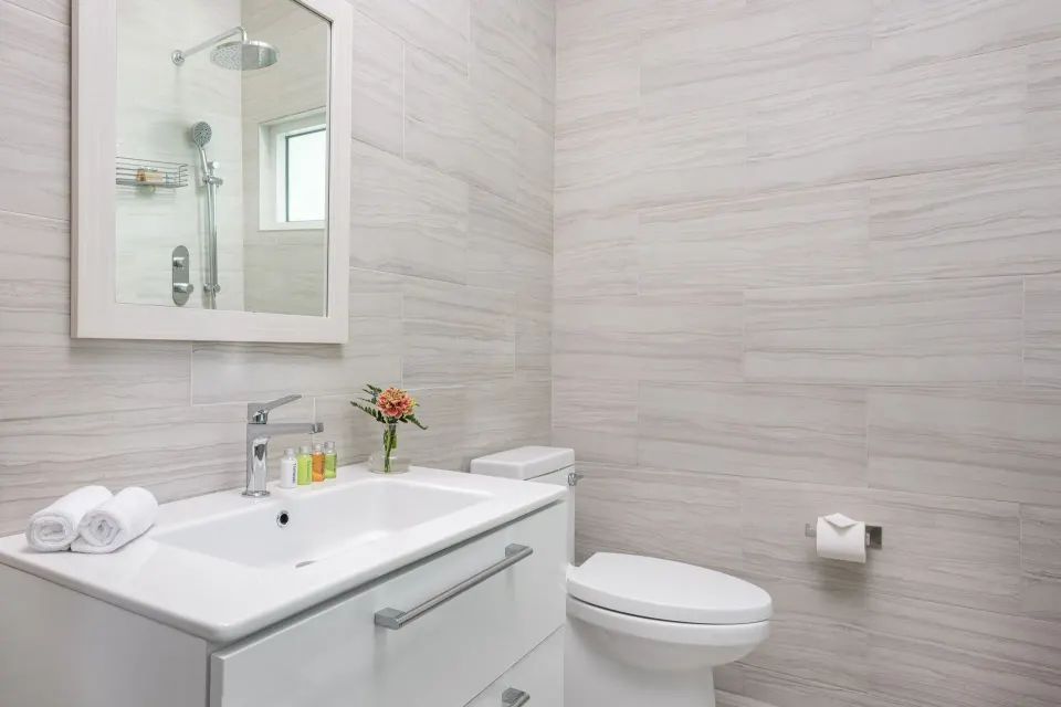 Deluxe Room bathroom vanity and toilet at The Oasis at Grace Bay.