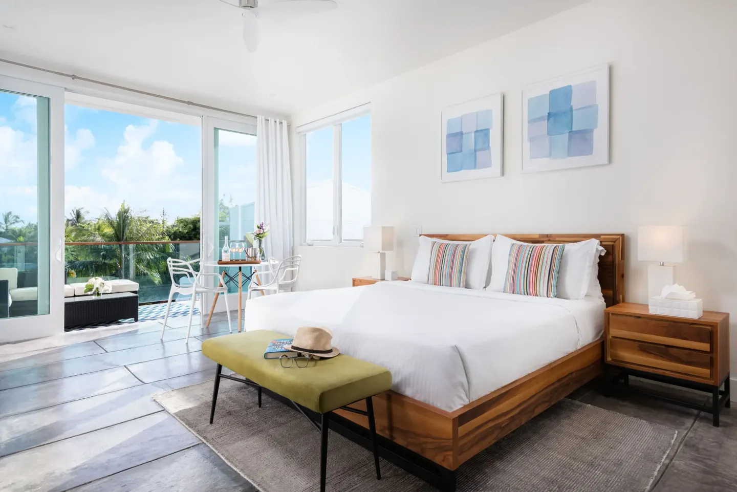 Luxury Room king bed with balcony doors at The Oasis at Grace Bay.