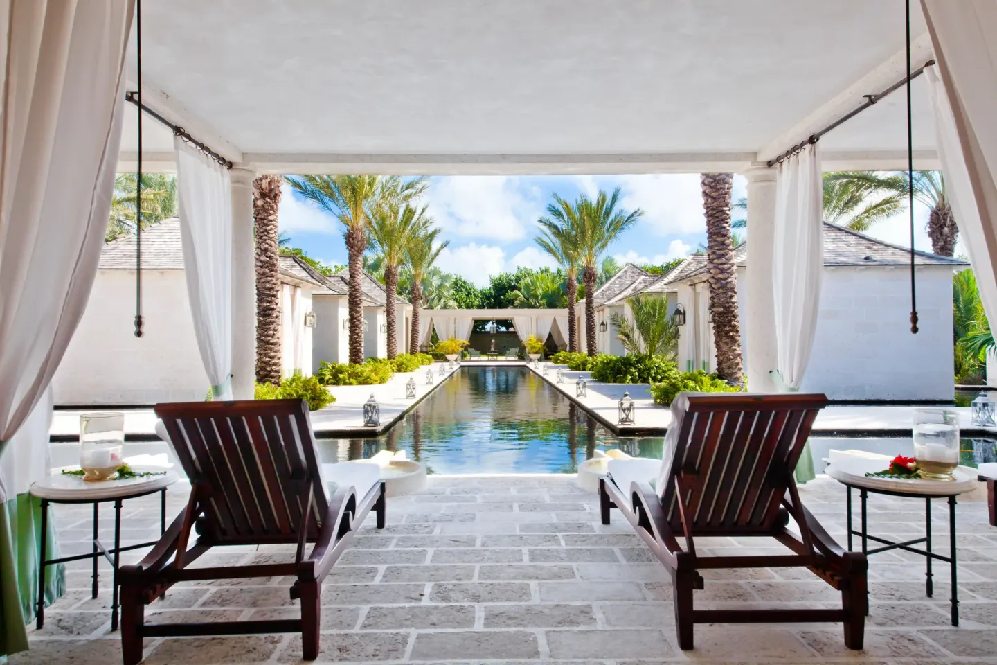 Covered lounge terrace overlooking a reflecting pool at The Palms Turks and Caicos.