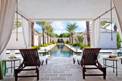 Covered lounge terrace overlooking a reflecting pool at The Palms Turks and Caicos.