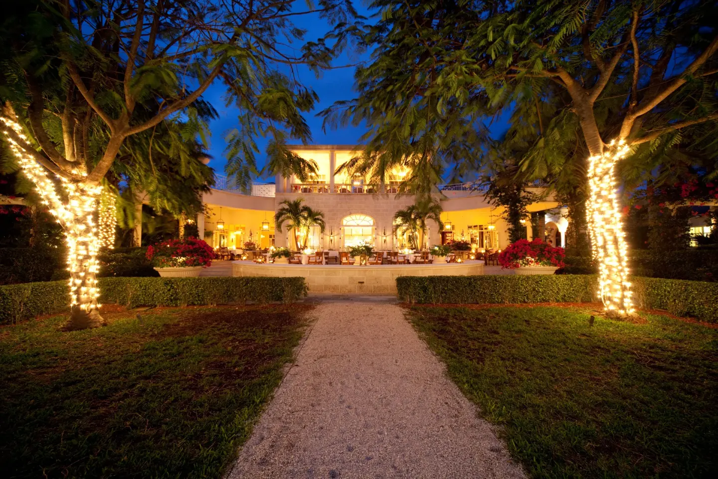 Illuminated garden path and resort terrace at night at The Palms Turks and Caicos.