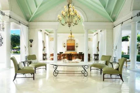 Open-air lobby seating with columns and chandeliers at The Palms Turks and Caicos.