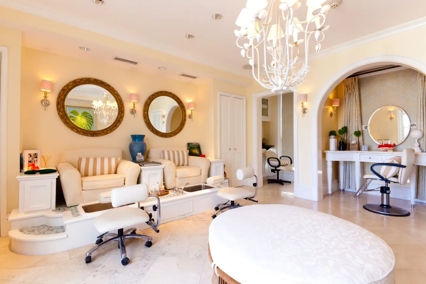 Bright spa salon with pedicure chairs and styling stations at The Palms Turks and Caicos.