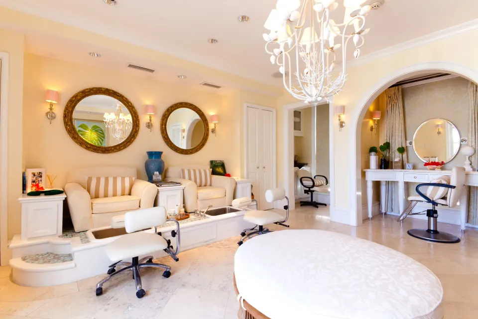 Bright spa salon with pedicure chairs and styling stations at The Palms Turks and Caicos.