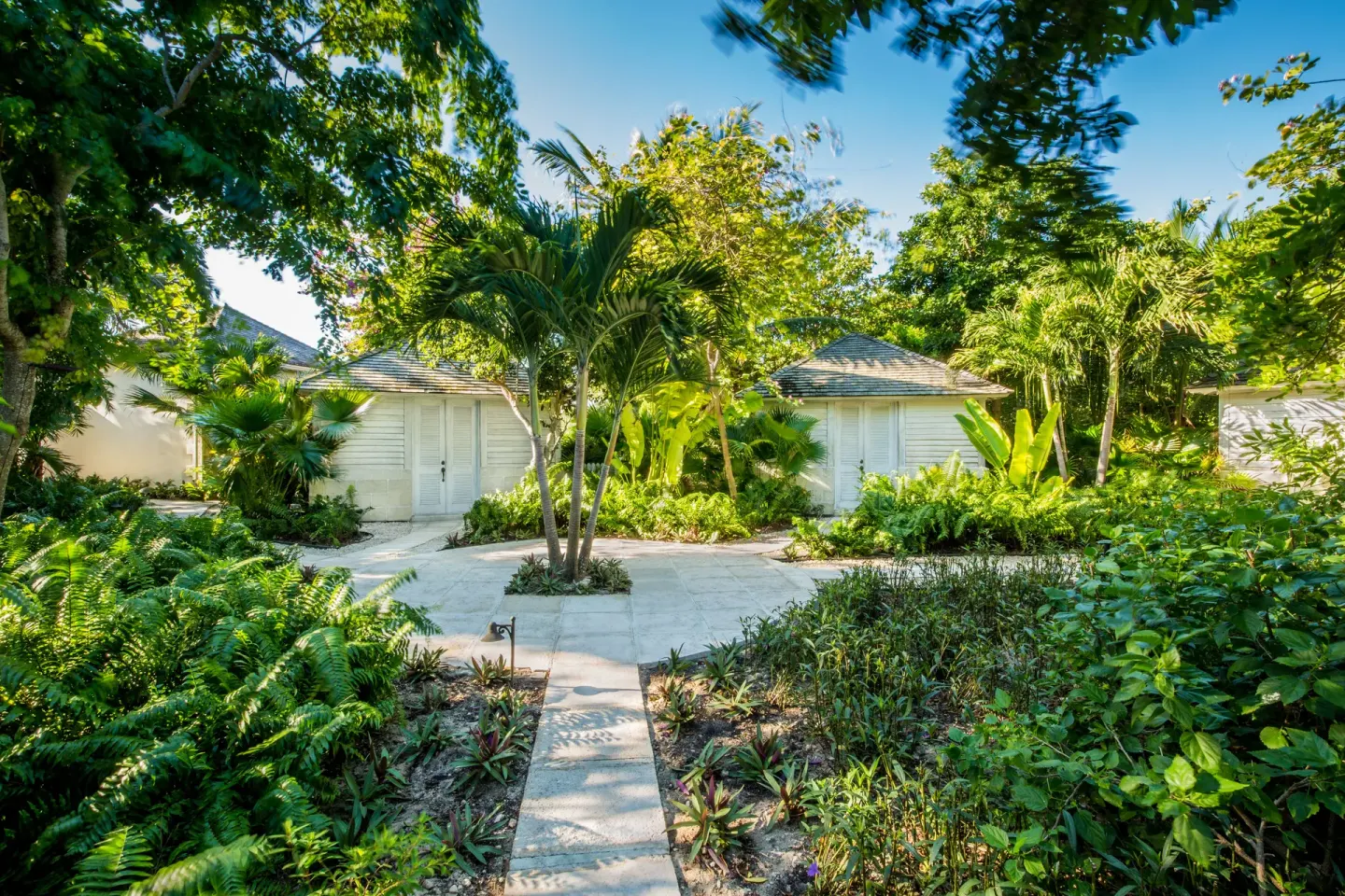 Tropical garden paths and villa-style buildings at The Palms Turks and Caicos.