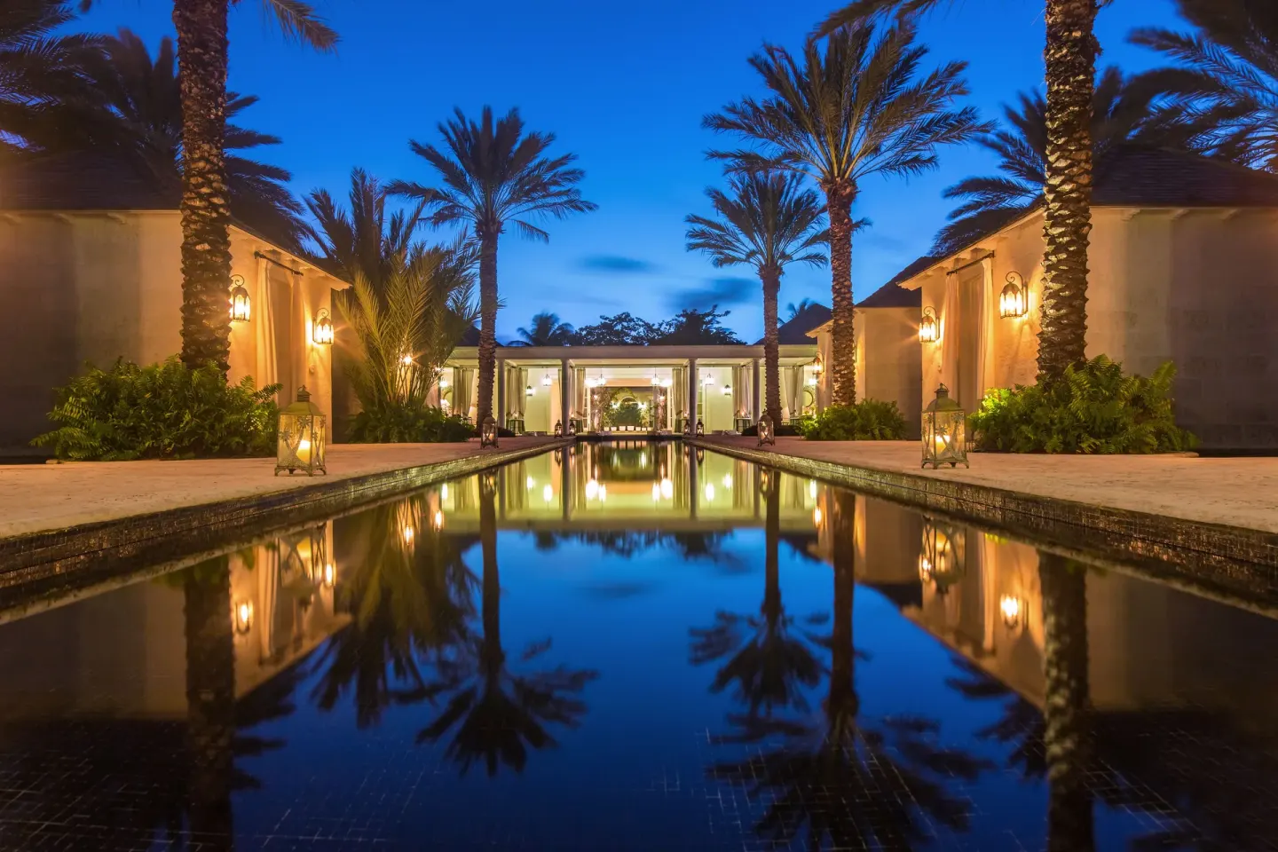Reflecting pool and palms at twilight at The Palms Turks and Caicos.