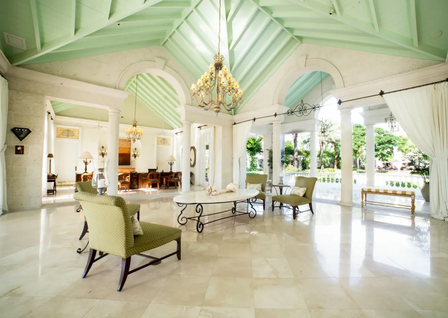 Spacious lobby lounge with vaulted ceiling and garden views at The Palms Turks and Caicos.