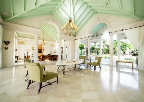 Spacious lobby lounge with vaulted ceiling and garden views at The Palms Turks and Caicos.