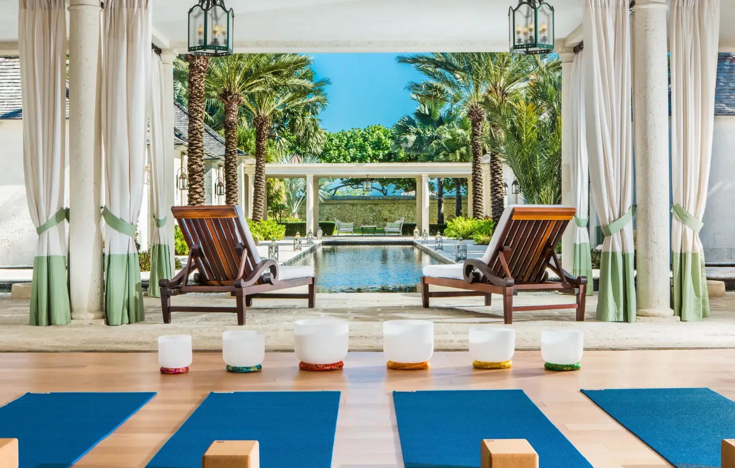 Yoga mats and singing bowls facing a reflecting pool at The Palms Turks and Caicos.