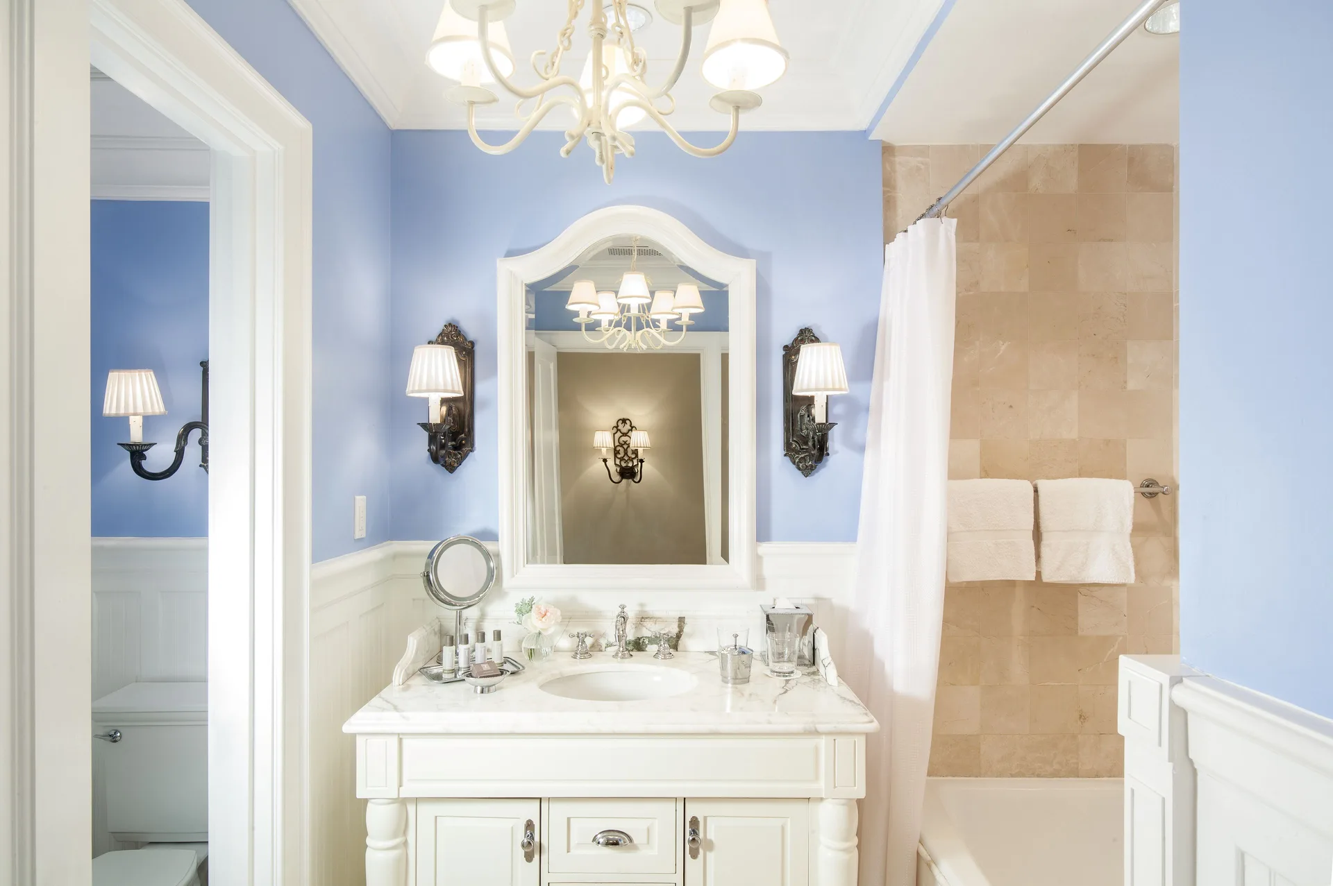 Junior Suite blue bathroom with vanity and tub at The Palms Turks and Caicos.