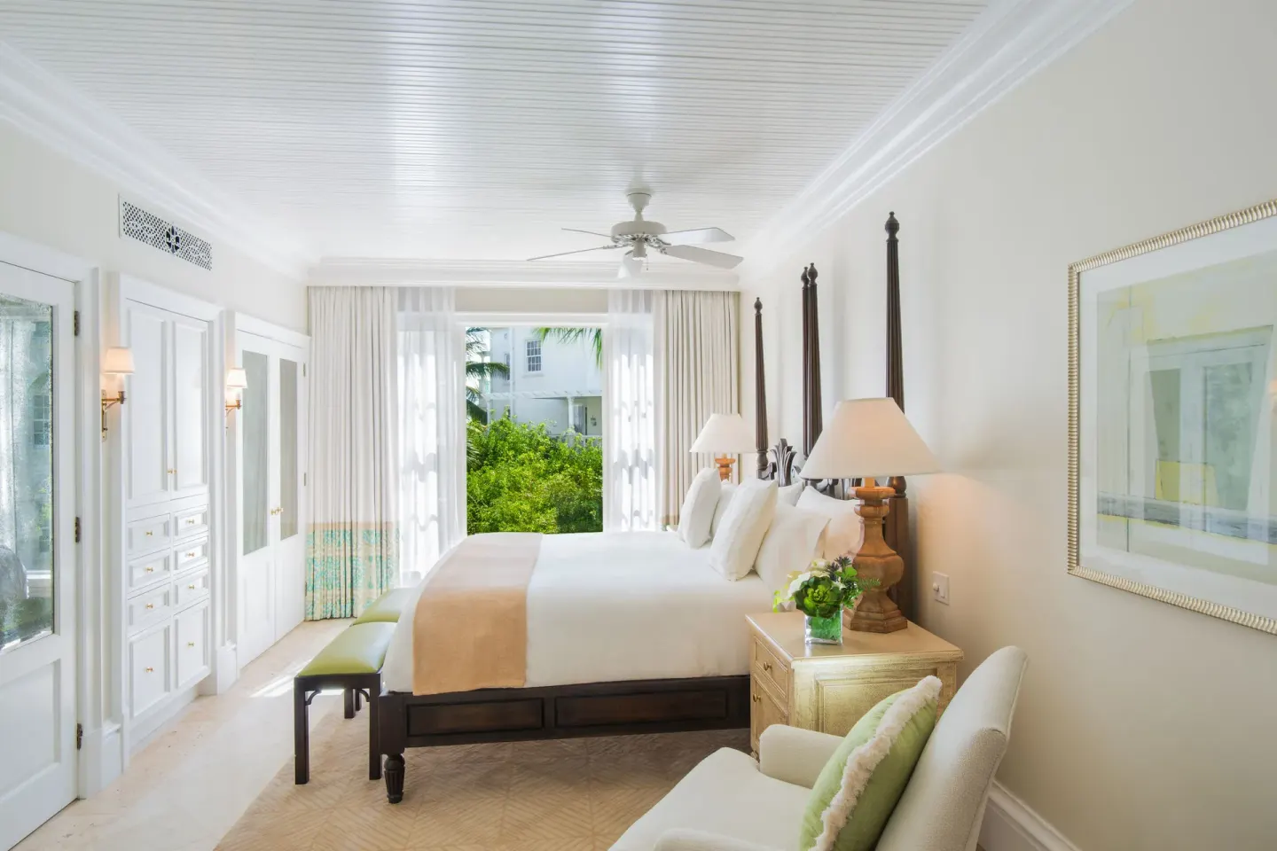 Junior Suite four-poster king bed and window seating at The Palms Turks and Caicos.